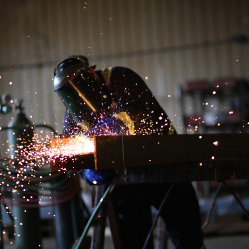 Person cutting steel with sparks