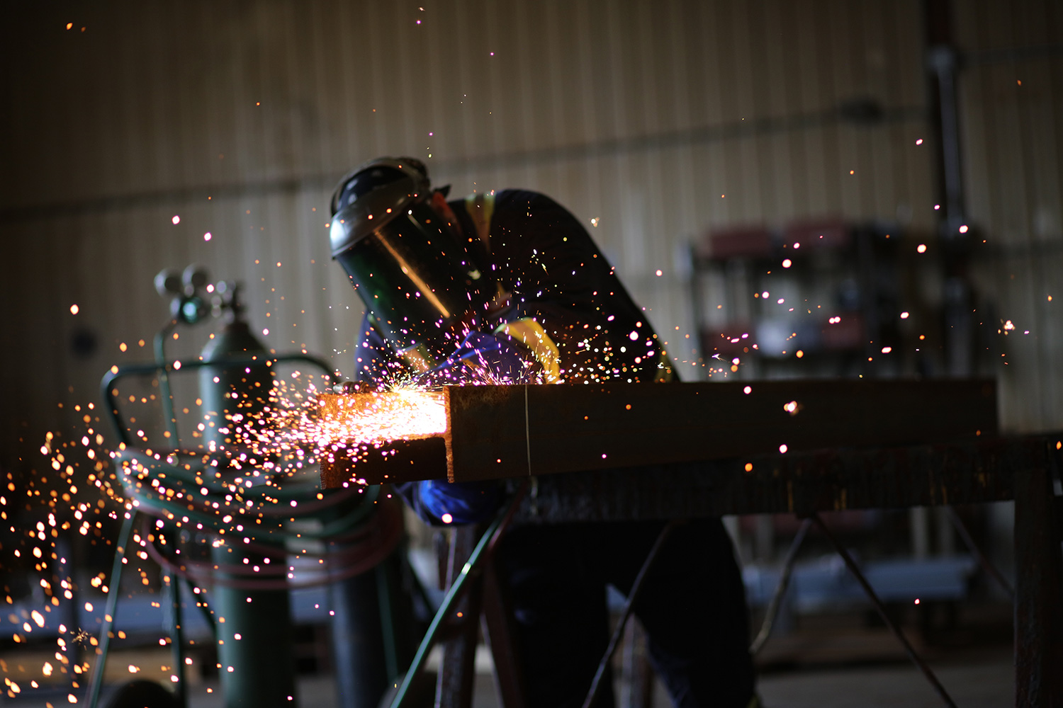 Person cutting steel with sparks